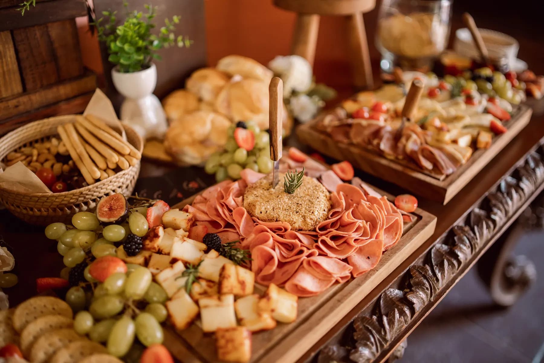 A catering board of meats, cheeses, and fruit